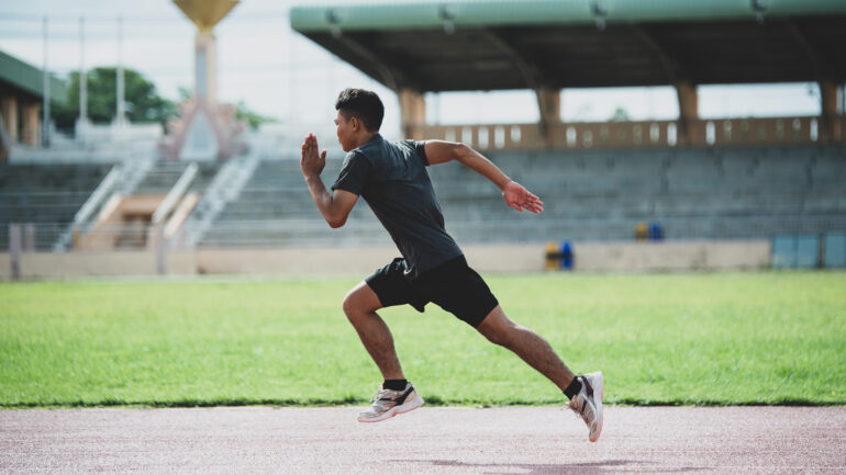 athlete standing on an all-weather running track