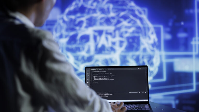 Admin writes AI code on laptop