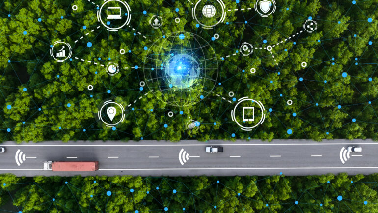 Aerial top view driverless car and hydrogen-powered truck cruising along green forest highway. Future of sustainable transport with electric vehicles and renewable energy in eco-friendly environment.