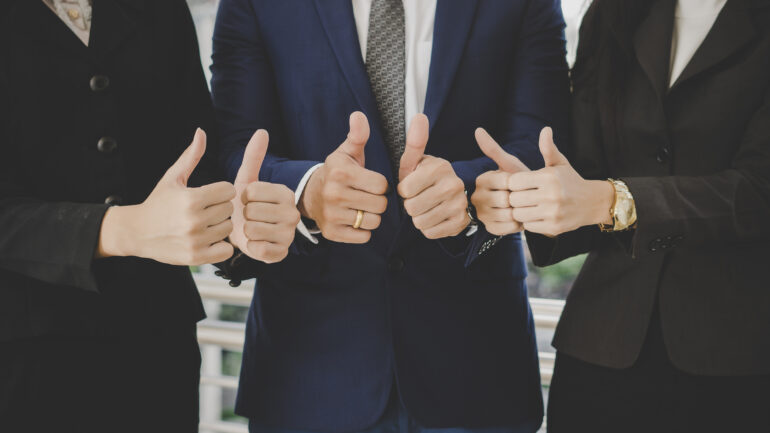 Business team standing in front of office successful business wi