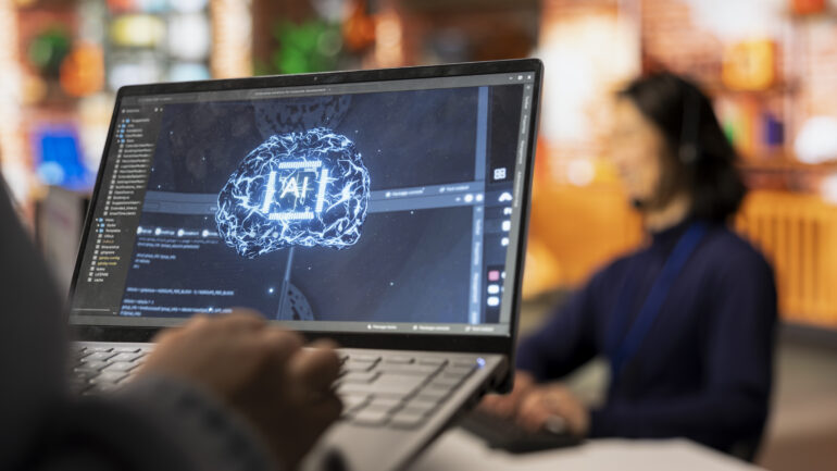 Call center worker using AI tech on laptop to reply to customers, closeup