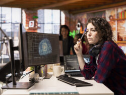 Woman working in AI tech agency providing custom software development services