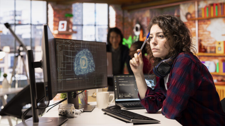 Woman working in AI tech agency providing custom software development services